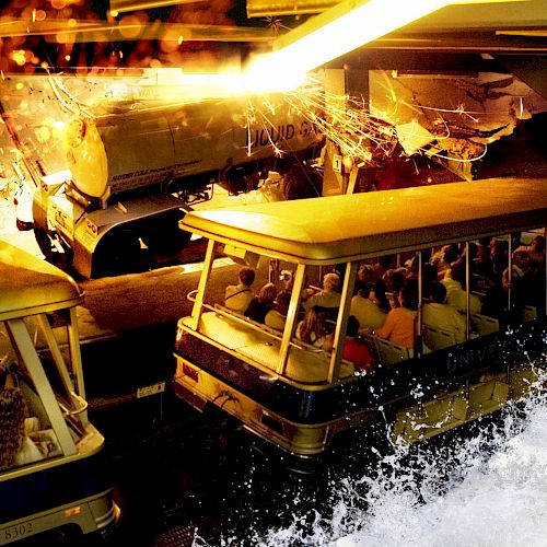 People are sitting in a theme park tram ride, experiencing an attraction with simulated explosions and water effects ending the sentence.