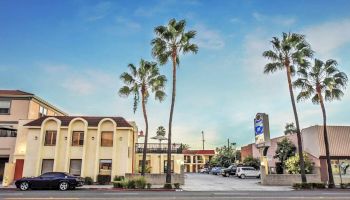 The image shows a motel with a sign reading 